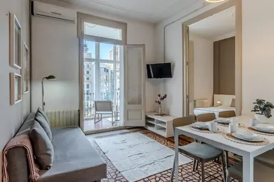 a living room with a table and a dining room at AB Bailen Apartments in Barcelona