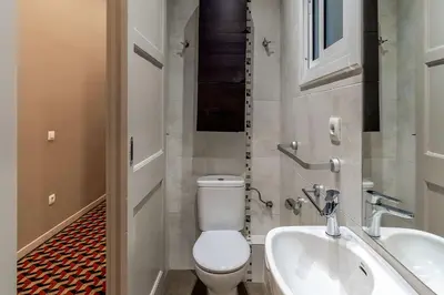 a bathroom with a toilet and a sink at AB Bailen Apartments in Barcelona