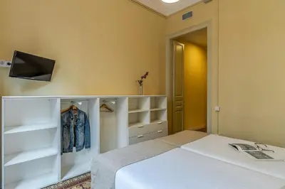 a bedroom with a bed and a tv on a wall at AB Bailen Apartments in Barcelona