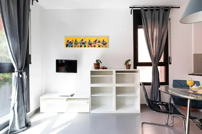 a living room with a desk and a table at AB Plaça de Sants in Barcelona