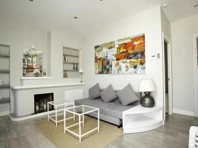 a living room with a couch and a fireplace at Sitges Spaces Bonaire Penthouse in Sitges