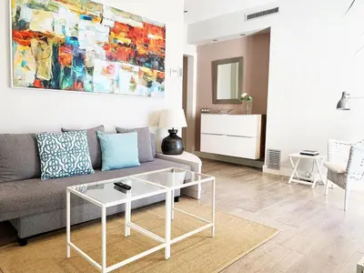 a living room with a couch and a table at Sitges Spaces Bonaire Penthouse in Sitges