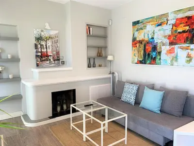a living room with a couch and a fireplace at Sitges Spaces Bonaire Penthouse in Sitges