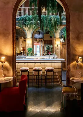 a restaurant with red chairs and a table and a bar at chic&basic Habana Hoose in Barcelona