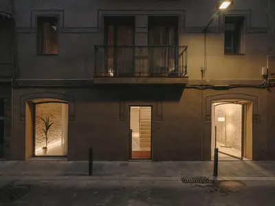 a building with three doors and a balcony at Boutique Apartments 23 Barcelona in Barcelona
