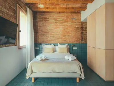 a bedroom with a bed with towels on it at Boutique Apartments 23 Barcelona in Barcelona