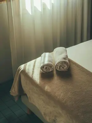 two towels sitting on top of a bed at Boutique Apartments 23 Barcelona in Barcelona