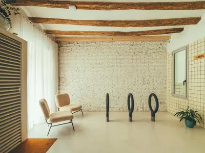 a room with two chairs and a brick wall at Boutique Apartments 23 Barcelona in Barcelona