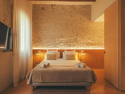 a bedroom with a bed with two stuffed animals on it at Boutique Apartments 23 Barcelona in Barcelona