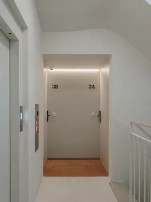 a hallway with a white door with numbers on it at Boutique Apartments 23 Barcelona in Barcelona