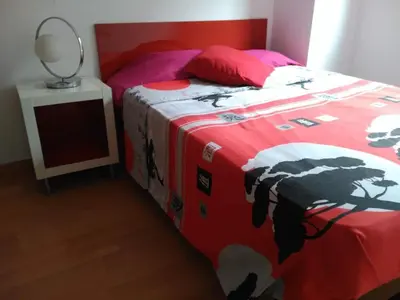a bedroom with a bed with a cow blanket at 2 BEDROOMS and 2 BATHROOMS FOR 5 PAX, SWIMMING POOL, FREE PARKING and NEAR THE BEACH! in Sant Adria de Besos