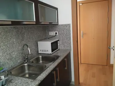 a kitchen with a sink and a microwave at 2 BEDROOMS and 2 BATHROOMS FOR 5 PAX, SWIMMING POOL, FREE PARKING and NEAR THE BEACH! in Sant Adria de Besos