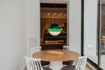 a table and chairs in a room with a piano at Petit Luxe St. Pere in Terrassa