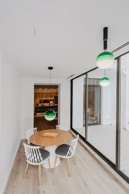 a kitchen and dining room with a table and chairs at Petit Luxe St. Pere in Terrassa