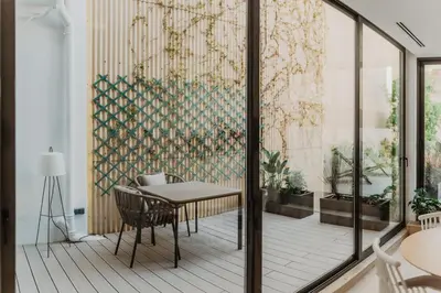 a dining room with a table and chairs on a balcony at Petit Luxe St. Pere in Terrassa