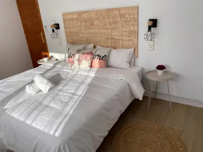 a bedroom with a large white bed with pillows at Vilamarlux VI in Vilassar de Mar