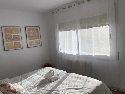 a bedroom with a bed and a window at Vilamarlux VI in Vilassar de Mar