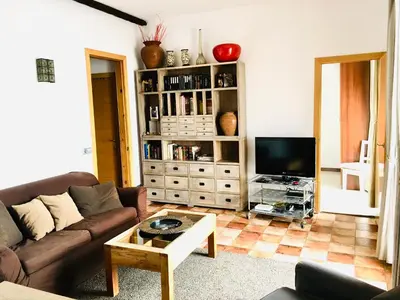 a living room with a couch and a tv at Barceloneta Ramblas Apartments in Barcelona