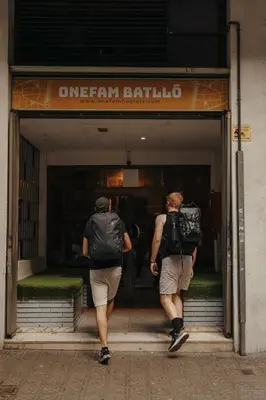 two people walking out of a store window at Onefam Batlló in Barcelona