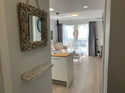 a living room with a mirror on the wall at Formentor in Castelldefels