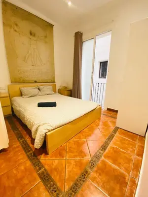 a bedroom with a bed and a large window at 03 cozy barça 2,1 in Barcelona