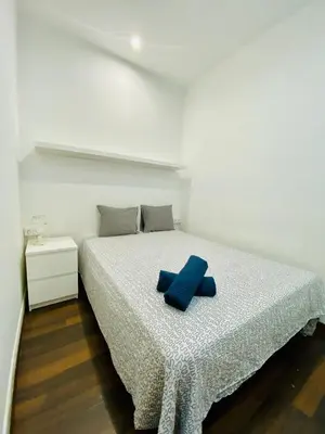 a bedroom with a bed with a blue pillow on it at 028 Apartament 2 2 in Barcelona