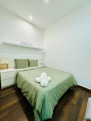 a bedroom with a bed with two towels on it at 028 Apartament 2 2 in Barcelona