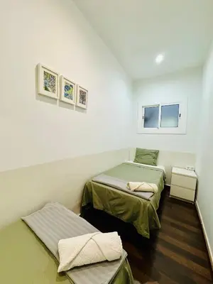 a room with two beds and a window at 028 Apartament 2 2 in Barcelona