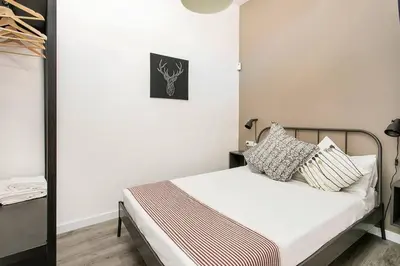 a small bedroom with a bed with pillows on it at Cozy&new With Terrace in Hospitalet de Llobregat