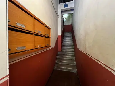 a stairway in a hallway with wooden cabinets and stairs at Apartamento Clsico Con Terraza in Barcelona