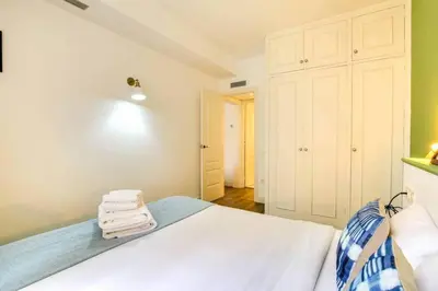 a bedroom with a bed with towels on it at Colorful With Cozy Terrace In Gracia in Barcelona