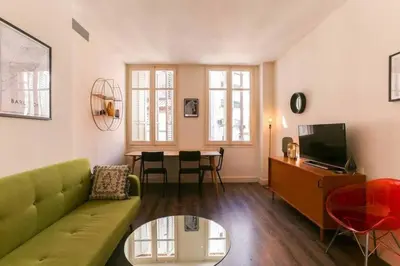 a living room with a green couch and a table at Stylish 2 Bdr In Trendy Gracia in Barcelona