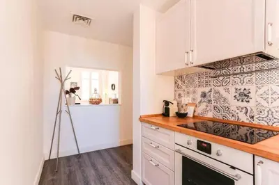 a kitchen with white cabinets and a counter top at Stylish 2 Bdr In Trendy Gracia in Barcelona