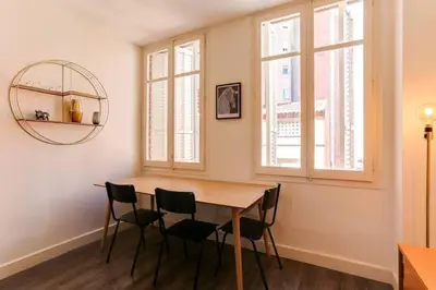 a dining room with a wooden table and chairs at Stylish 2 Bdr In Trendy Gracia in Barcelona