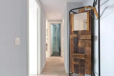 a hallway with a wooden door and a mirror at 2 Bdr Penthouse In Grcia in Barcelona