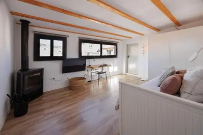 a living room with a couch and a fireplace at Atico duplex Playa Area barcelona con SPA exterior in Montgat