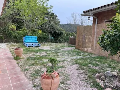 a yard with a blue couch in a backyard at Raconet Azul - Circuito Cataluña in Vallromanas