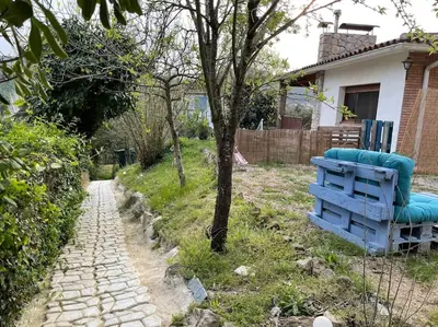 a blue bench in a yard next to a house at Raconet Azul - Circuito Cataluña in Vallromanas