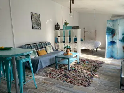 a living room with a couch and a table at Raconet Azul - Circuito Cataluña in Vallromanas