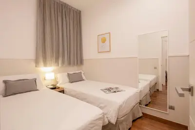 a hotel room with two beds and a mirror at Aspasios Market Balconies Apartments in Barcelona