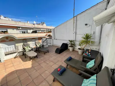 a patio with couches and chairs on a building at Sea Dreams with Amazing Terrace in Sitges