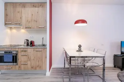 a kitchen and dining room with a table and chairs at Magical Design With Terrace in Hospitalet de Llobregat