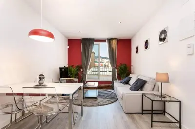 a living room with a white couch and a table at Magical Design With Terrace in Hospitalet de Llobregat