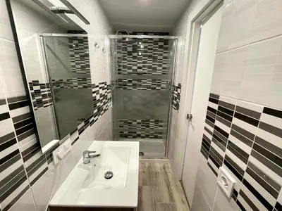 a bathroom with a sink and a shower at Sant Adria Beach apartment Wi-Fi Parking Free in Sant Adria de Besos