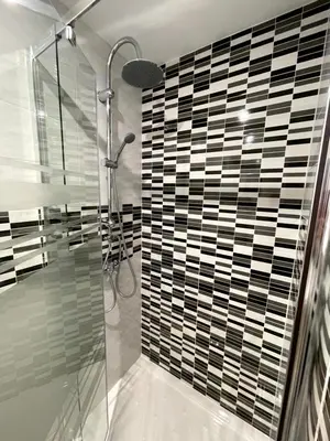 a bathroom with a shower and a glass wall at Sant Adria Beach apartment Wi-Fi Parking Free in Sant Adria de Besos