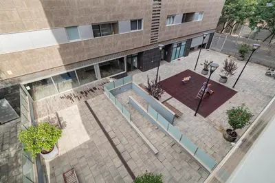 an overhead view of a courtyard in front of a building at FORUM BEACH 2 AND POOL APARTMENT BARCELONA in Sant Adria de Besos