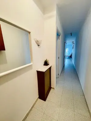a hallway with a window and a table on a wall at Barca 1 in Sant Adria de Besos
