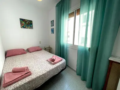 a bedroom with a bed with pink towels on it at Barca 1 in Sant Adria de Besos