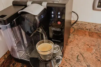 a coffee maker with a cup of coffee on a counter at Collbato Resort. in Collbató