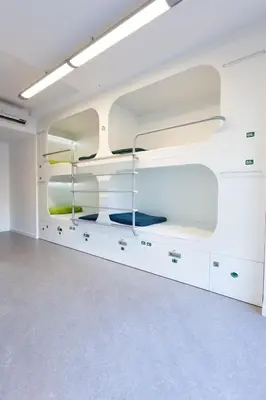 an empty room with white walls and shelves at Dream Cube Hostel in Barcelona